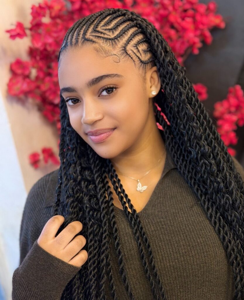 Young Black woman showcasing intricate cornrows and long textured braids