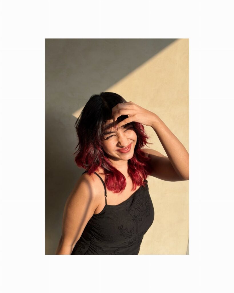 Woman with dark hair dyed vivid red and burgundy at the ends